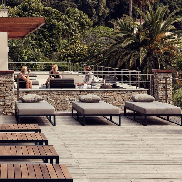 Image of row of 3 Roshults Garden Easy daybeds with cozy Sunbrella cushions, shown on sunny wooden decking