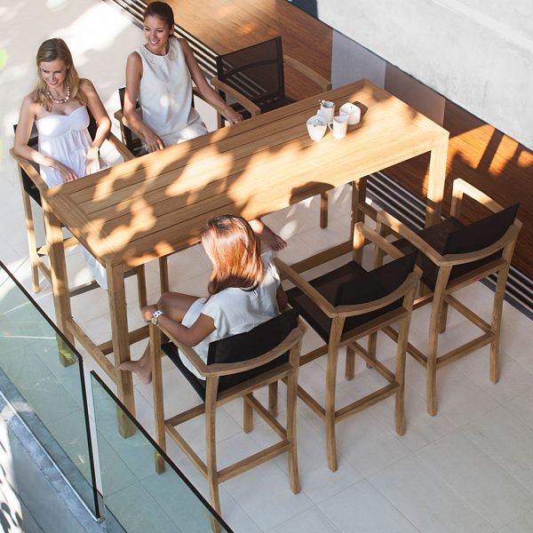 Birdseye image of group of friends sat around XQI exterior bar furniture by Royal Botania