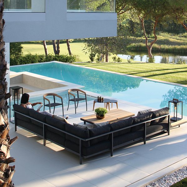 Alura garden corner sofa in black next to swimming pool