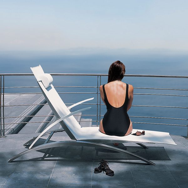Image of woman sat on Royal Botania OZON 195T sun lounger whilst looking out to sea