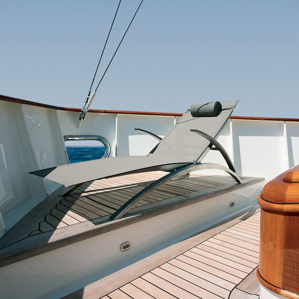 Image of Royal Botania OZON sun lounger in stainless steel and taupe on teak deck of yacht