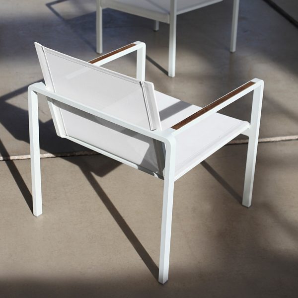 Image of white Alura lounge chair in white with teak arm inserts by Royal Botania