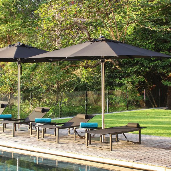 Image of black Shady parasols and black Ninix sun loungers by Royal Botania on poolside