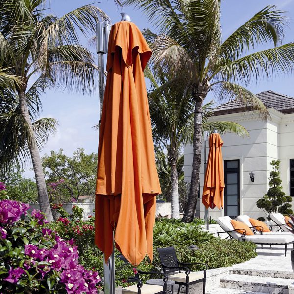 Image of closed Ocean Master Max cantilever parasols with orange canopies by Tuuci