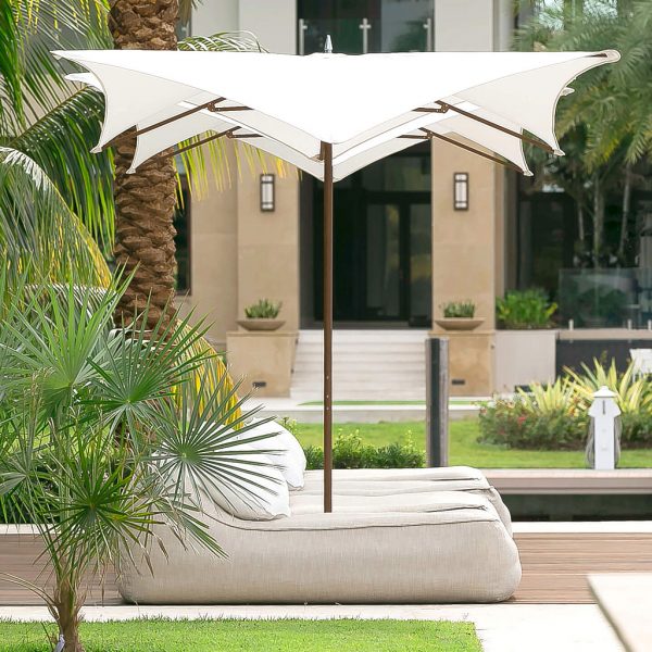 Image of Tuuci Manta parasols with white canopy and Aluma-Teak mast and ribs, with cozy bean bags on terrace beneath