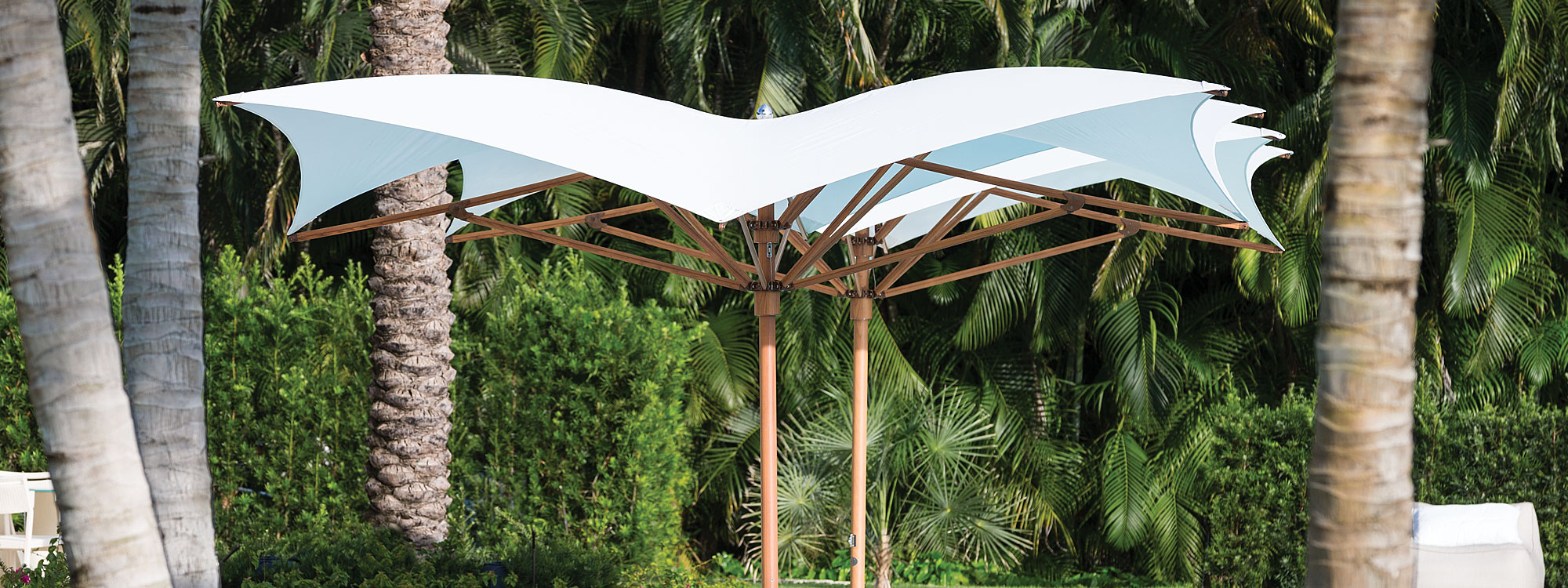 Image of pair of Ocean Master Max mast parasols with Aluma Teak wood-effect mast and ribs and white canopies