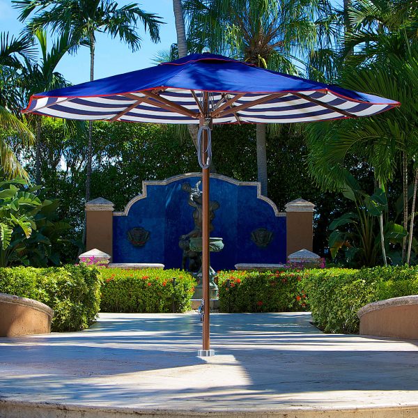 Image of Tuuci Ocean Master Max centre post parasol with mast and ribs in Aluma-teak and contrasting color canopy, with flush mounting on concrete floor