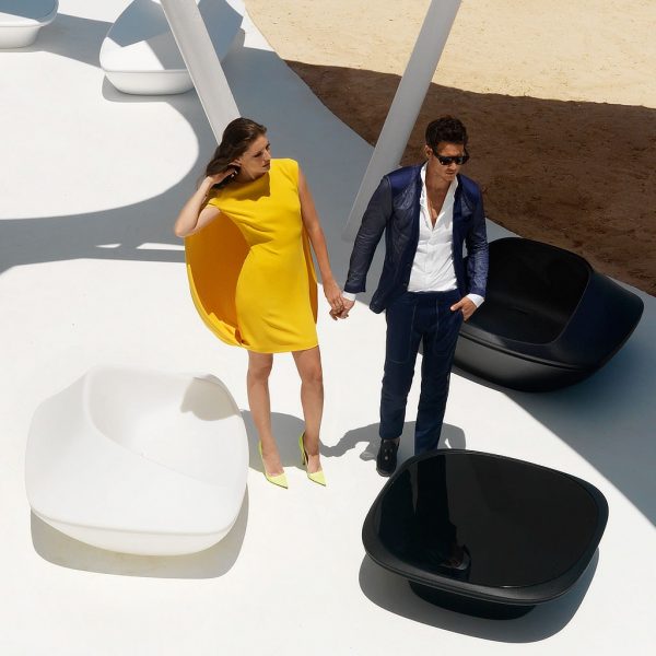 Image of couple stood on terrace in between Vondom UFO futuristic outdoor furniture on white terrace