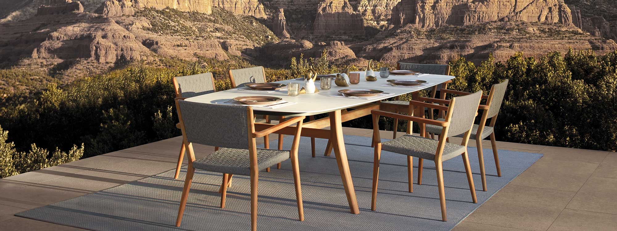 Image of Royal Botania dining furniture placed on a grey outdoor rug