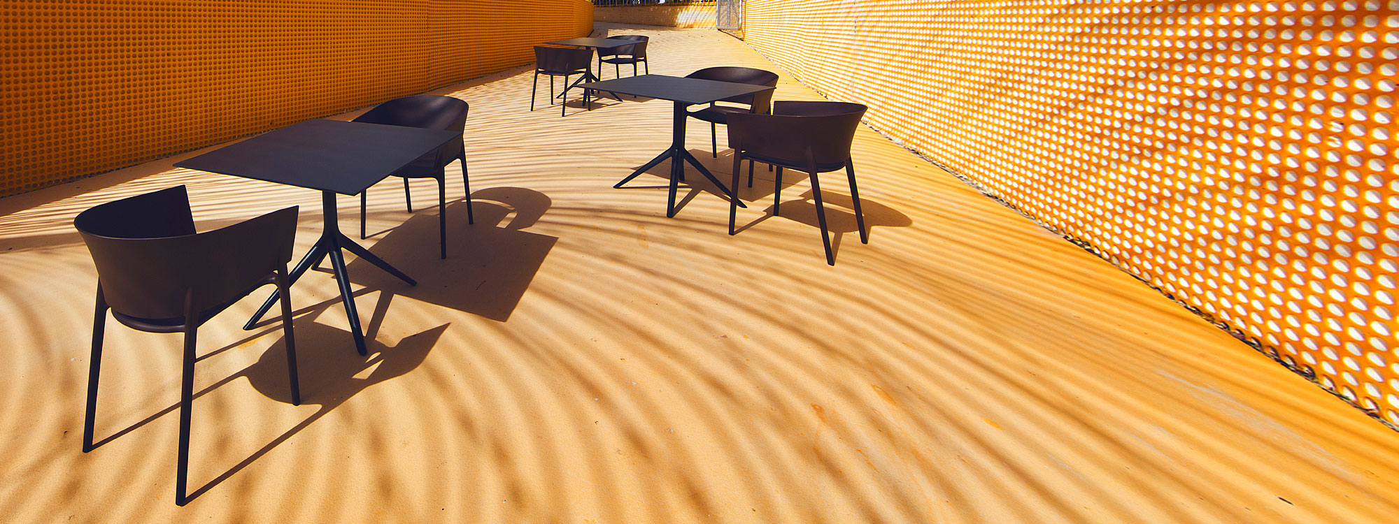 Image of black Africa modern plastic contract chairs and Mari-sol bistro tables by Vondom