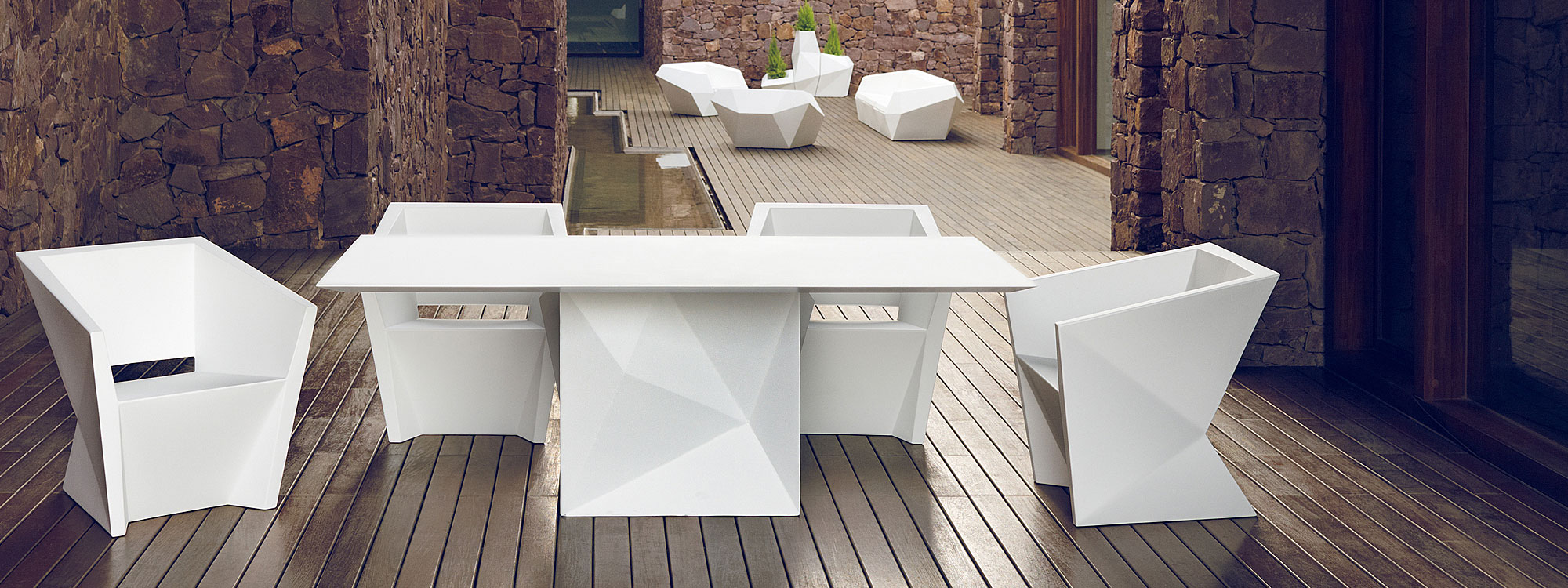Image of Vondom Faz modern white garden dining furniture in peaceful courtyard terrace