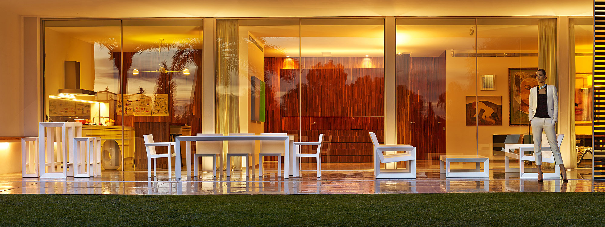 Image of terrace at dusk with Frame minimalist garden furniture by Vondom in white roto-molded polyethylene