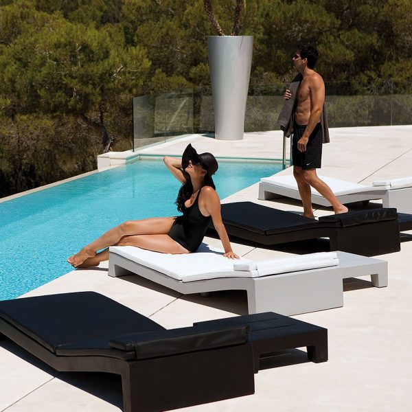 Image of black and white Jut sun loungers by Vondom on sunny poolside