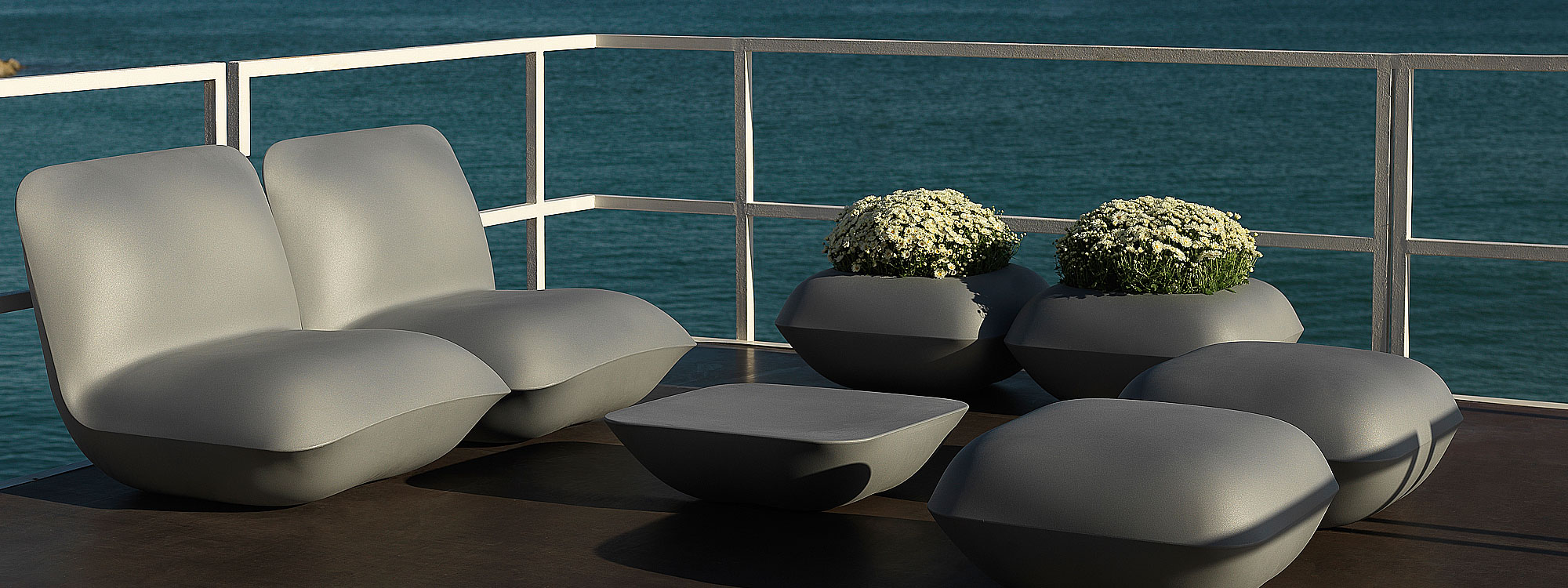 Image of steel coloured Pillow lounge furniture by Vondom on waterside terrace