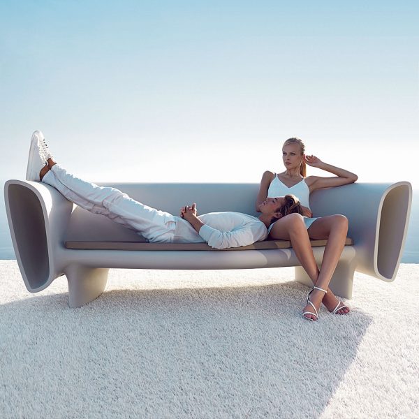 Image of man lying with his head in the lap of woman who is sat on Vondom Bum Bum modern 3 seat garden sofa