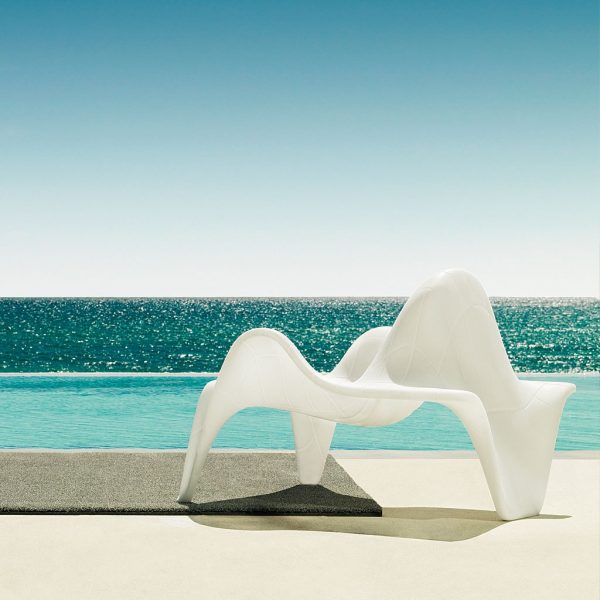 Image of Vondom F3 white outdoor relax chair with mathematically curved design by Image of woman comfortably say on Vondom F3 garden easy chair with mathematically precise design by Fabio Novembre