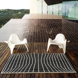 Image of pair of Vondom F3 white contemporary garden lounge chairs by Image of Vondom F3 white outdoor relax chair with mathematically curved design by Image of woman comfortably say on Vondom F3 garden easy chair with mathematically precise design by Fabio Novembre