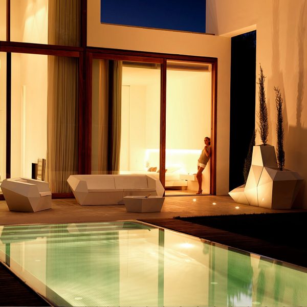 Nighttime image of modern terrace and poolside with Vondom Faz modern outdoor lounge furniture