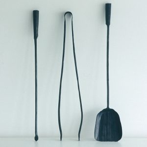 A Ferro e Fuoco hand forged fire tools are a modern companion set with stand or wall mounted fire tools in recycled steel by Conmoto, Germany