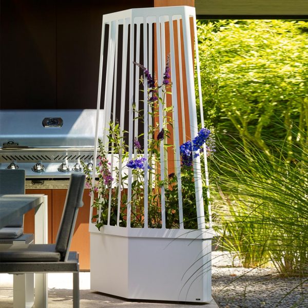 Image of Flora Air planter with wheels and trellis next to plants and outdoor kitchen