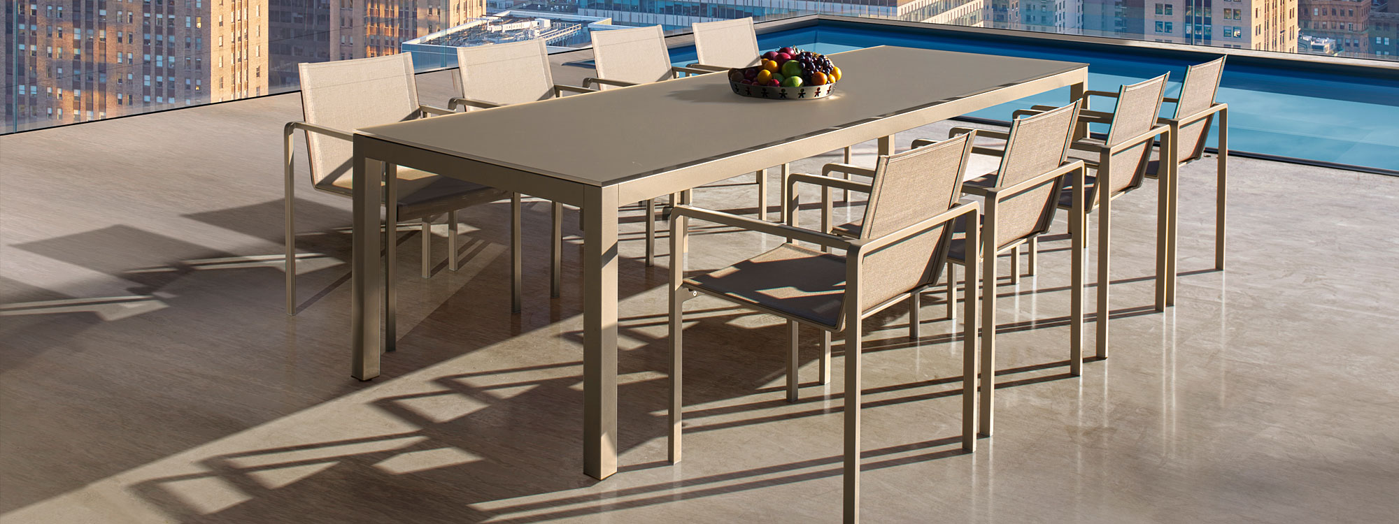 Image of city rooftop installation of sand coloured Alura garden chairs & Sand coloured Taboela table by Royal Botania