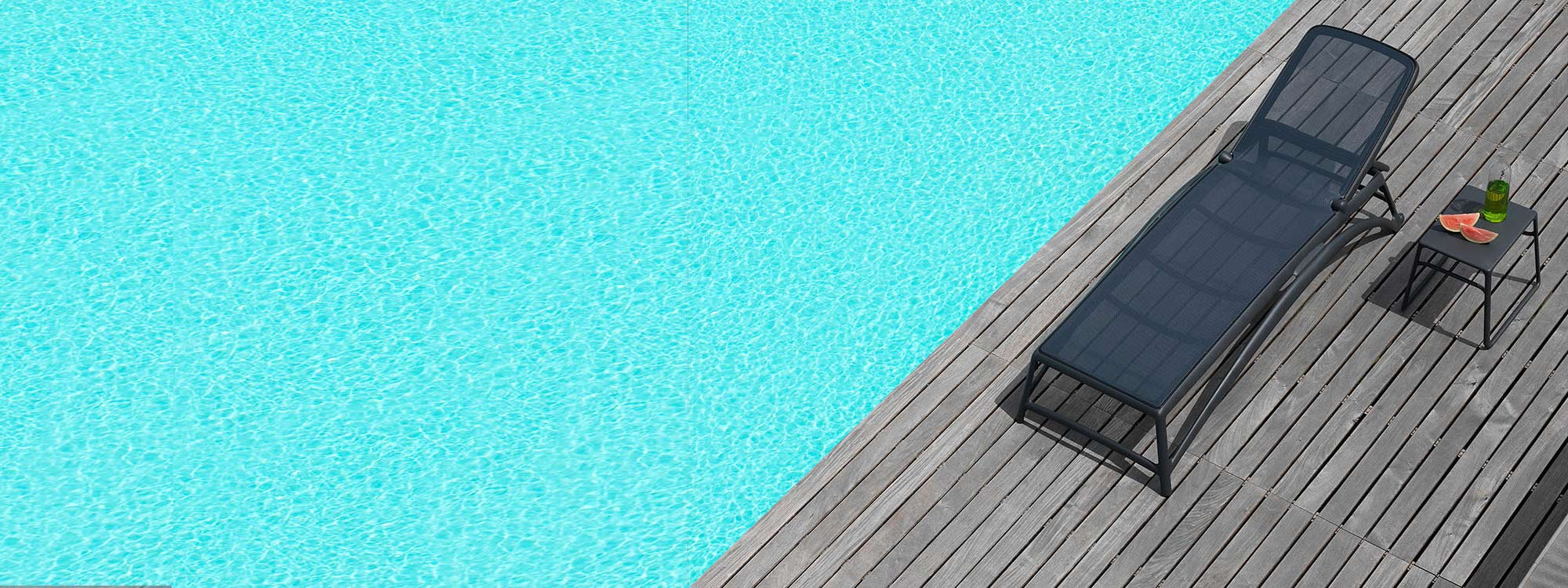 Image of aerial view of Atlantico anthracite contract sun lounger and Pop side table by Nardi, shown on wooden-decked poolside