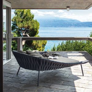 Image of RODA Arena daybed on balcony overlooking Italian lake and hills in far distance.