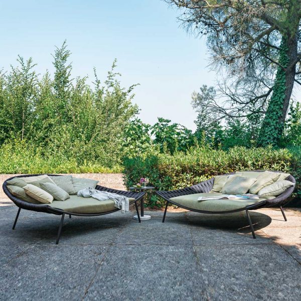 Image of pair of RODA daybeds with Bernardo coffee table in the centre, with trees and shrubs in background