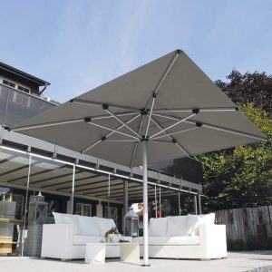 Image of Shademaker Astral large square parasol on terrace above white outdoor sofas.
