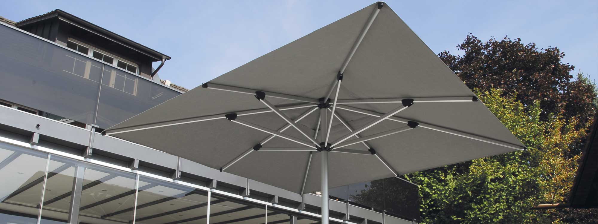 Image showing underside of Shademaker Astral large centre pole parasol's aluminium mast and ribs, and taupe acrylic fabric canopy