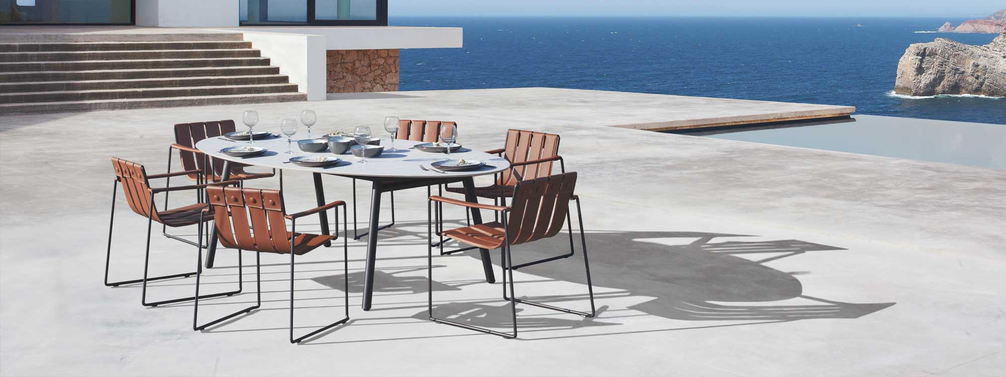 Bace table & Strappy garden dining chair is a modern outdoor carver chair in minimalist outdoor furniture materials by Royal Botania luxury exterior furniture