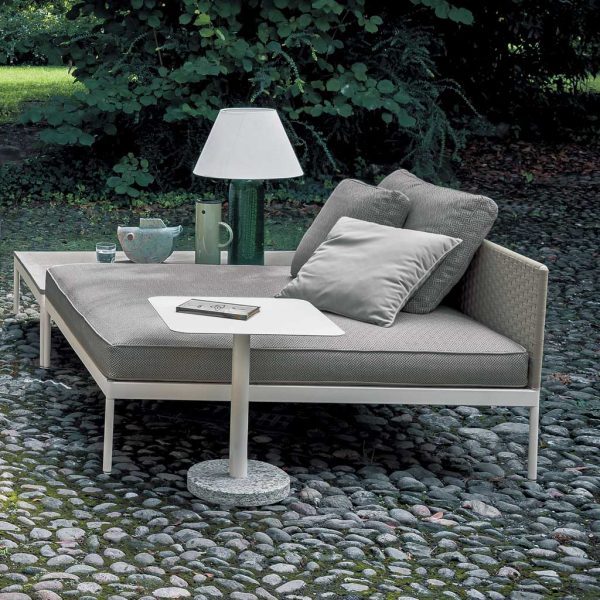 Image of Basket garden daybed with white frame and taupe cushions on cobblestone floor