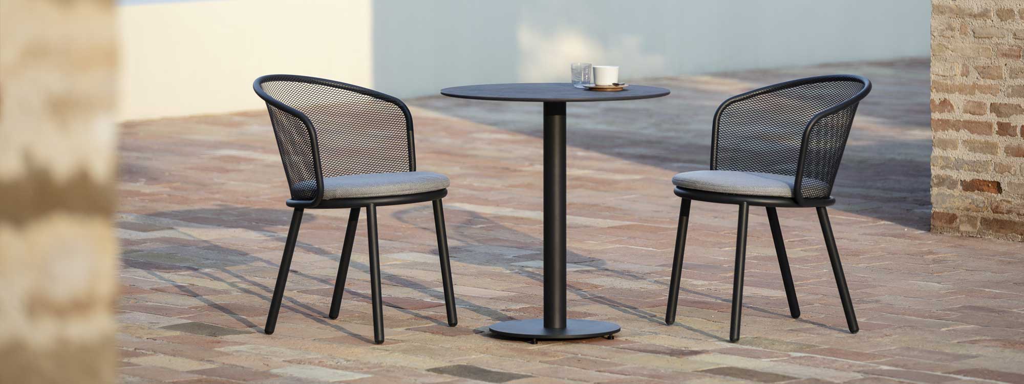 Anthracite Baza outdoor chair and Branta bistro table in courtyard