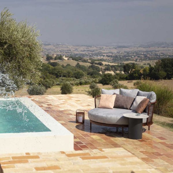 Image of Baza modern garden daybed being splashed as someone jumps into swimming pool