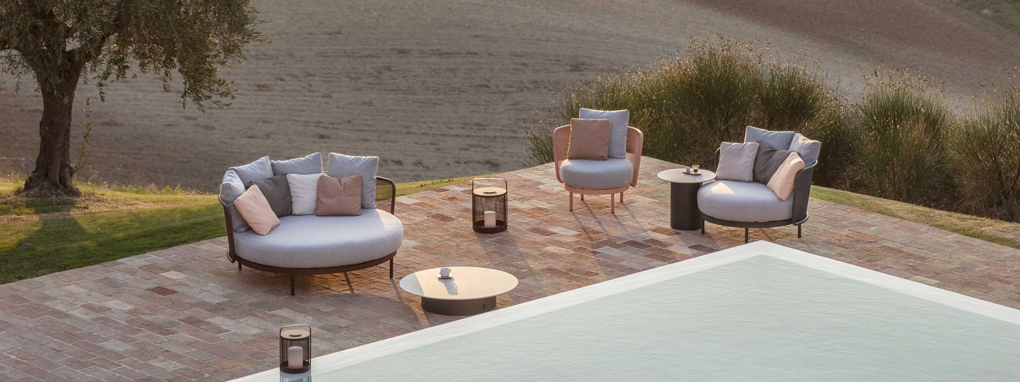 Baza exterior day bed and Baza Club outdoor lounge chair with Luci garden lanterns and Branta low table on terrace