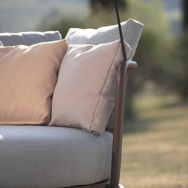 Image of detail of Rust-Brown stainless steel frame & Grey and Salmon-Beige cushions of Baza garden swing chair, designed by Studio Segers for Todus.