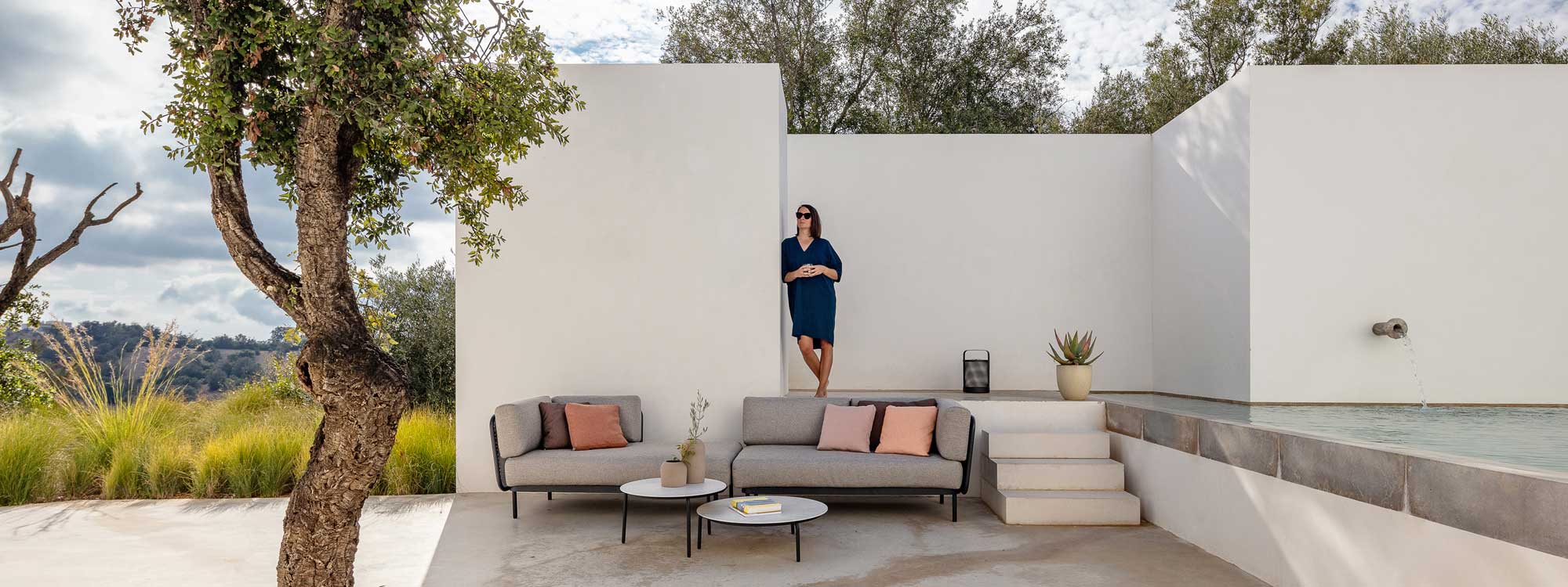 Baza modern outdoor sofa on Portuguese terrace between olive tree and swimming pool