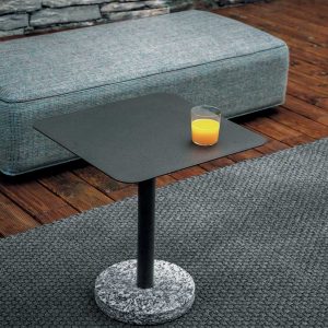 Bernardo modern outdoor side table with glass of orange juice on top