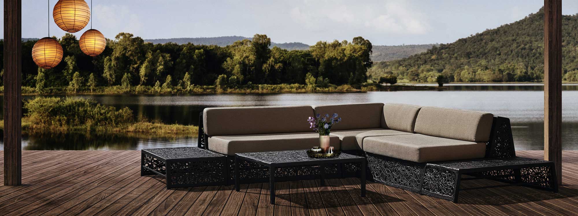 Image of Bios Lounge corner sofa in black basalt fiber by Unknown Furniture, with lake and hills in background