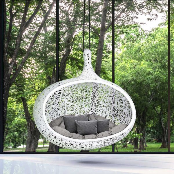 Image of white Bios Hide garden sofa swing with woodland in the background