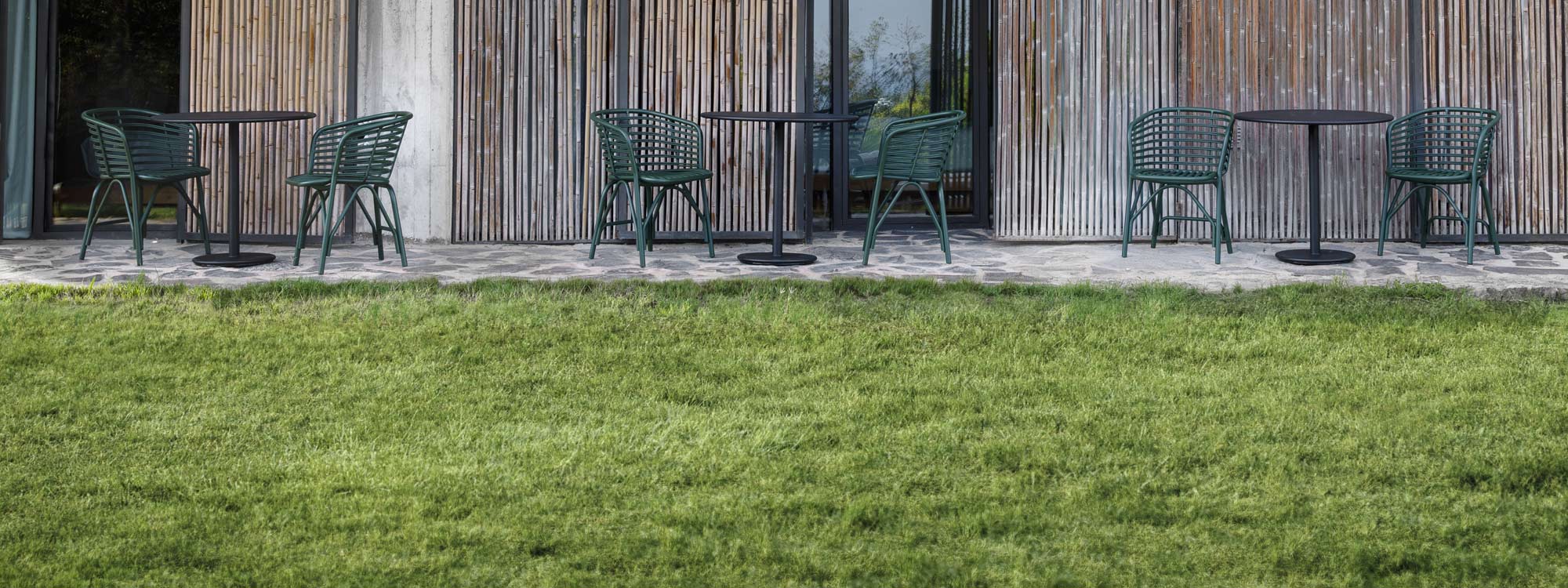 Image of Dark-green Blend chairs and Lava-grey Go tables on outdoor terrace by Cane-line
