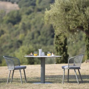 Light-Grey Branta round garden table and Baza modern garden chair with olive trees in background