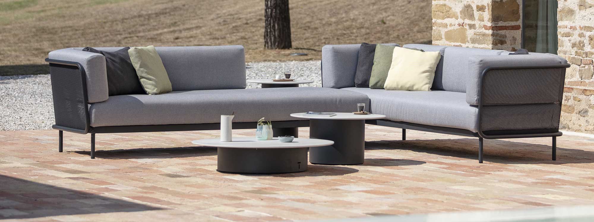 Branta modern garden coffee tables with Baza modular garden sofa on sunny terrace