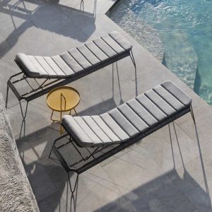 Image of grey Cane-line Breeze sun loungers casting long shadows on poolside