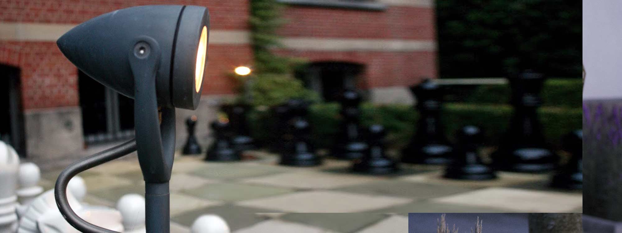 Image of Royal Botania garden spike light in zinc finish, with giant chess pieces in the background