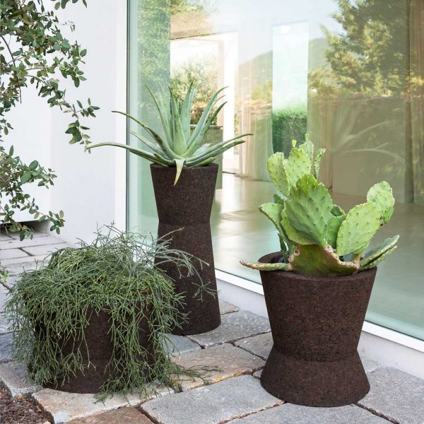 3 different sizes of Bush On cork planters planted with cacti and succulents, shown on balmy Italian terrace