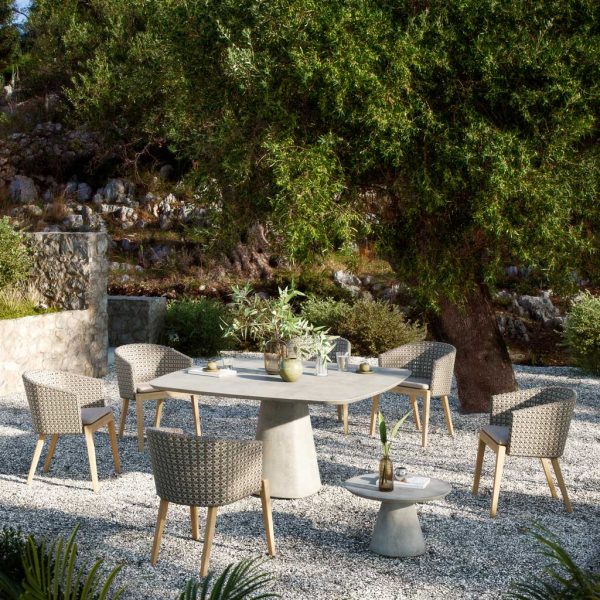Image of Royal Botania Conix concrete table & Calypso chairs with woven Kriss Kross backs on gravel terrace beneath tree