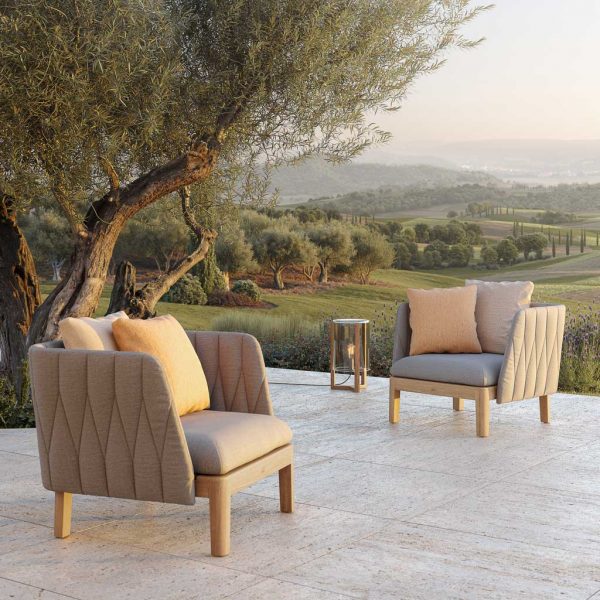 Image of pair of Royal Botania Calypso garden lounge chairs on balmy terrace at dusk
