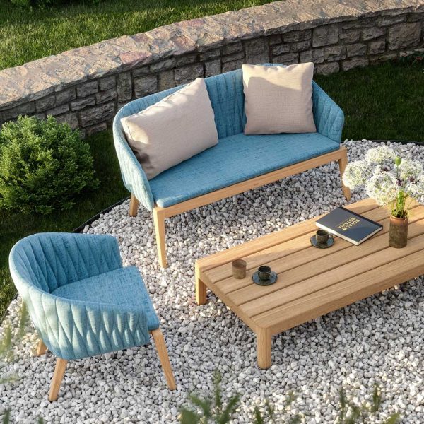 Birdseye view of Royal Botania Calypso sofa and easy chair on shingle terrace surrounded by verdant planting