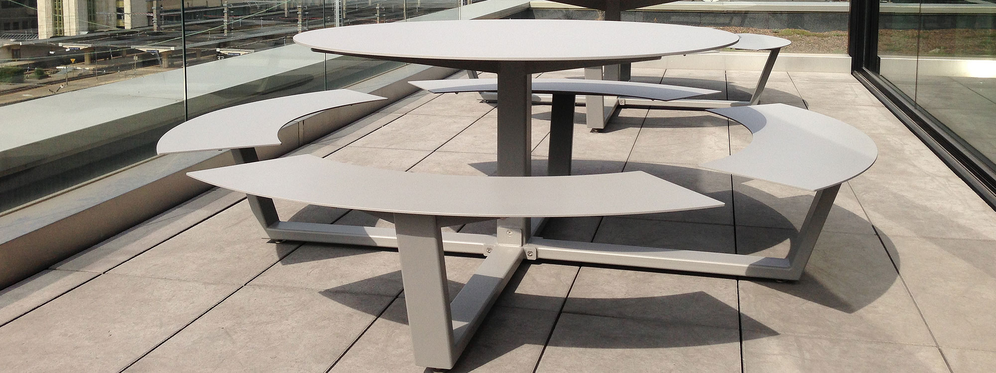 Image of pair of Taupe La Grande Ronde modern picnic tables by Cassecroute, on rooftop terrace